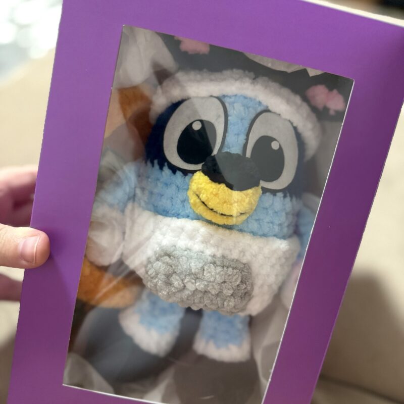 A stuffed dog and 4 sets of clothes for her